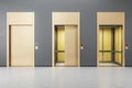 Grey concrete interior with three elevator doors. Opportunity and success concept. Royalty Free Stock Photo