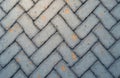 Grey concrete rectangular paving blocks form a detailed zig zag pattern. Close up view shows interlocking texture and subtle Royalty Free Stock Photo