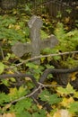 Grey concrete simple Orthodox Christian cross on an old autumn cemetery Royalty Free Stock Photo