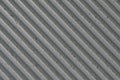 grey concrete wall with deep textured 3d lines diagonal