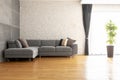 Grey Corner Couch On Wooden Floor Against Brick Wall In Bright A