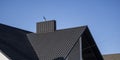 Grey corrugated metal profile roof installed on a modern house. The roof of corrugated sheet. Roofing of metal profile