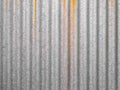 grey corrugated steel with rust leak