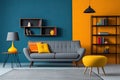 a grey couch with orange pillows in a room with blue walls Royalty Free Stock Photo