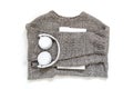 Grey cozy comfortable sweater with white headphones and tablet reader.