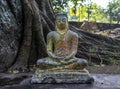 Grey cracked ancient small statue of Buddha Royalty Free Stock Photo