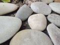 grey and creamy pebbles Stones and wet sand Royalty Free Stock Photo