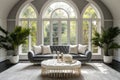 Grey curved tufted sofa in luxury room with arched windows. Hollywood glam home interior design of modern living room. Royalty Free Stock Photo