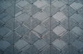 Grey decorative pavement tiles form intricate geometric pattern. Stone slabs create large diamond shapes, with smaller textured Royalty Free Stock Photo