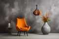 Grey decorative vase and orange pendant light near leather wingback chair against concrete stucco wall