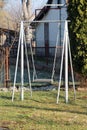 Grey dilapidated homemade outdoor playground equipment metal swing built in family house backyard Royalty Free Stock Photo