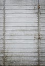 Grey, dirty metal door texture background. Creative, abstract backdrop. Old, rusty, worn iron garage door detail. Rough and grunge Royalty Free Stock Photo