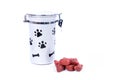 Grey doggy treat container with black pawprints and red meat snacks Royalty Free Stock Photo