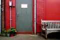 Grey door on red wall