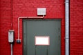 Grey door on red wall Royalty Free Stock Photo