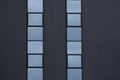 Grey e wall with two glass windows rows as background. Royalty Free Stock Photo