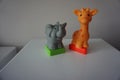 Grey elephant and orange giraffe. Plastic figures Royalty Free Stock Photo