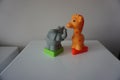 Grey elephant and orange giraffe. Plastic figures Royalty Free Stock Photo
