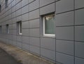 Grey facade with small square white Windows Royalty Free Stock Photo