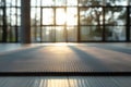 Grey fitness mat on a floor in a blurred yoga studio on background