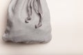 Grey fleece sack with tape on white background. Full tied container for small things, present concept. Top view, copy space. Royalty Free Stock Photo