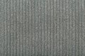 Grey flossy towel texture close up. Fluffy fabric with vertical stripes.