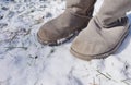 Grey fuzzy boots in the winter snow Royalty Free Stock Photo