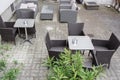 Grey garden furniture with flowers in pots on terrace of spacious hotel Vienna, Austria