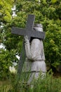 Granite statue of woman bearing the cross