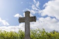 Grey Grave Stone Cross Standing Alone In Cemetery, Blue Sky Background