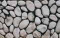 Grey or gray stone wall with natural texture round stone. Natural stone old style wall. Royalty Free Stock Photo