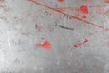 Grey grunge scratched metal sheet background. Worn steel surface texture with red paint Royalty Free Stock Photo