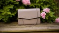 Elegant Khaki Leather Handbag With Taupe Colored Design On Wood Bench