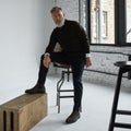 Grey hair serious man posing in spacious flat