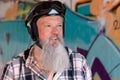 Grey-haired bearded biker in a retro helmet