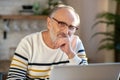 Grey-haired bearded senior man eyeglasses looking tired