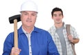 Grey-haired builder with apprentice Royalty Free Stock Photo