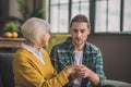 Grey-haired elderly lady feeling amazing with her son