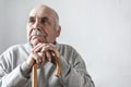 Grey haired elderly man with mustache thinking