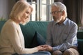 Grey haired husband comforting wife, holding hands, showing support Royalty Free Stock Photo