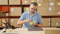 Grey-haired man ecommerce business eating salad at office Royalty Free Stock Photo