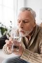 grey haired man with parkinsonism holding Royalty Free Stock Photo