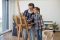 Child enjoying art making with grandpa in home studio