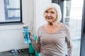Grey haired sportswoman with sports bottle
