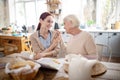 Grey-haired woman feeling thankful to caregiver Royalty Free Stock Photo