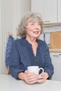 Grey haired woman with mug