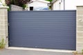 Grey high steel slide modern gate gray aluminum sliding portal of home door of suburbs house Royalty Free Stock Photo