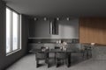 Grey home kitchen interior with cooking and dining area, panoramic window Royalty Free Stock Photo
