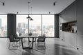 Grey home kitchen interior with eating table and shelves, panoramic window Royalty Free Stock Photo