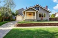 Grey house exterior with white porch and orange door Royalty Free Stock Photo